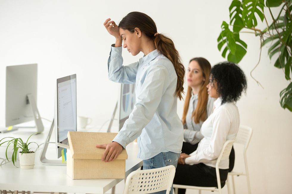 Business woman takes a minute to compose herself after being laid off during the recession.