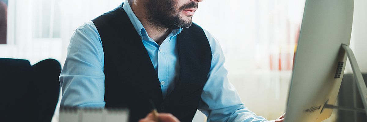 Businessman does some research for upskilling on the job.