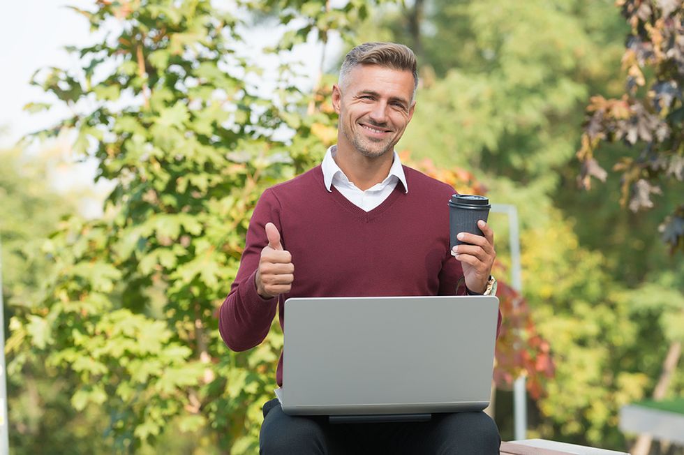 Businessman enjoys reading a career growth blog.