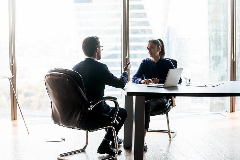 Businessman has a serious discussion with his boss.