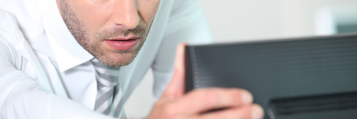 Businessman looks over his LinkedIn profile.