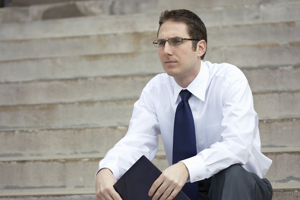 Businessman takes a break from his job search during a recession.