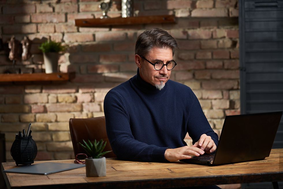 Businessman talks to counselor via video.