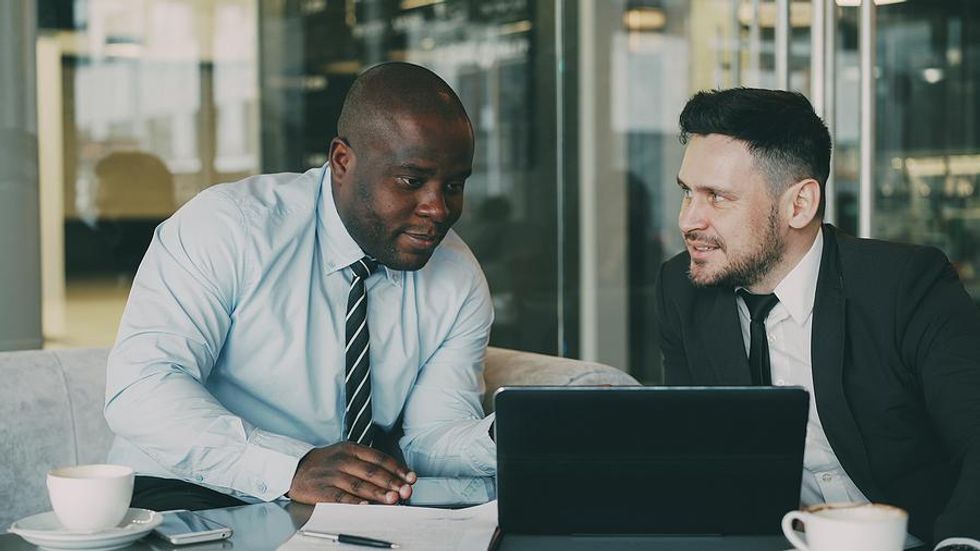 Businessmen talk to each other and read each other's emotions during a meeting