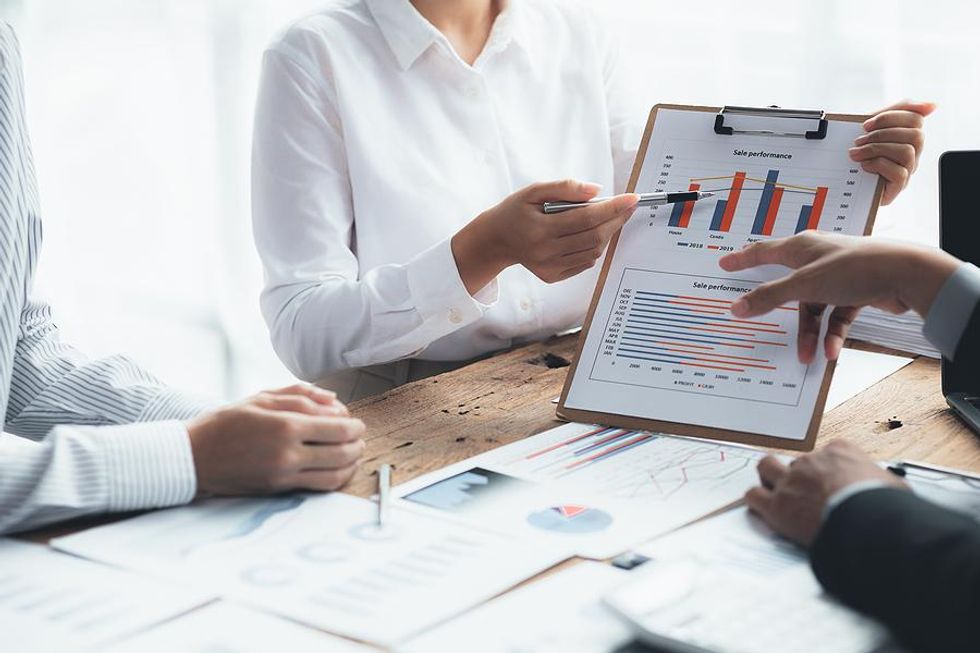 Businesspeople discuss sales during a work meeting