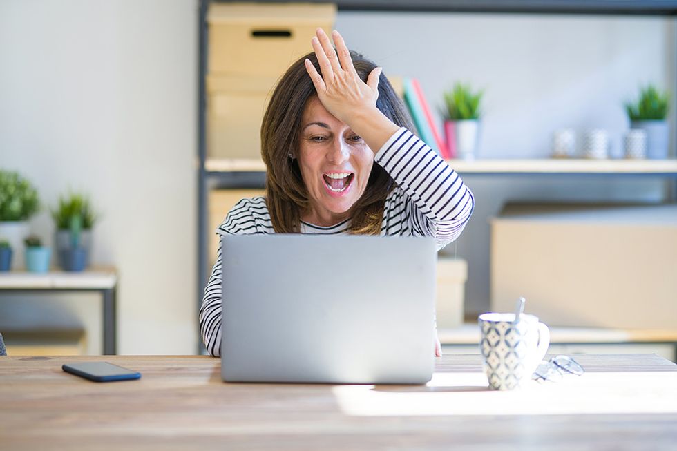 Businesswoman show frustration over a mistake she made in her cover letter.