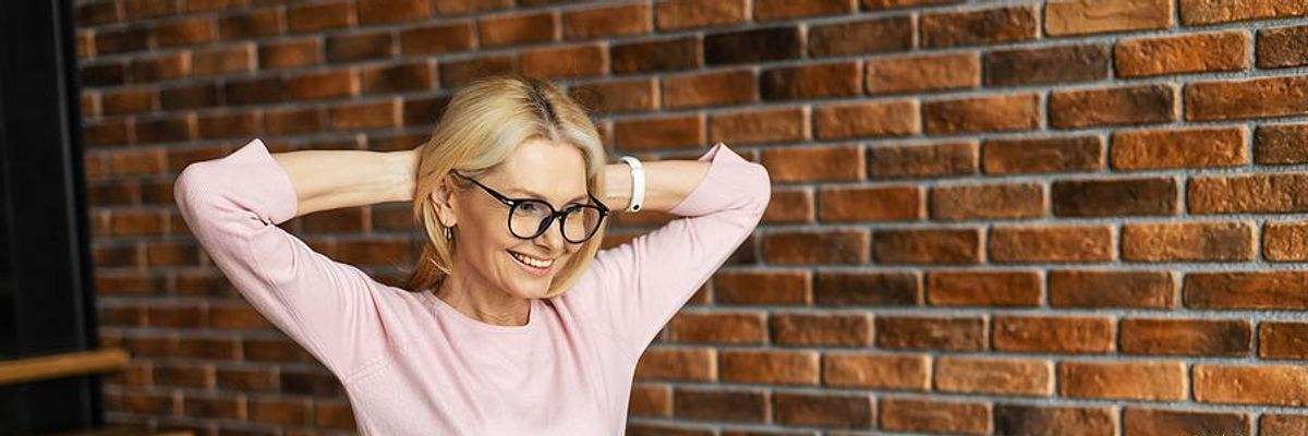 Businesswoman smiles after reading a recommendation that she received on LinkedIn.