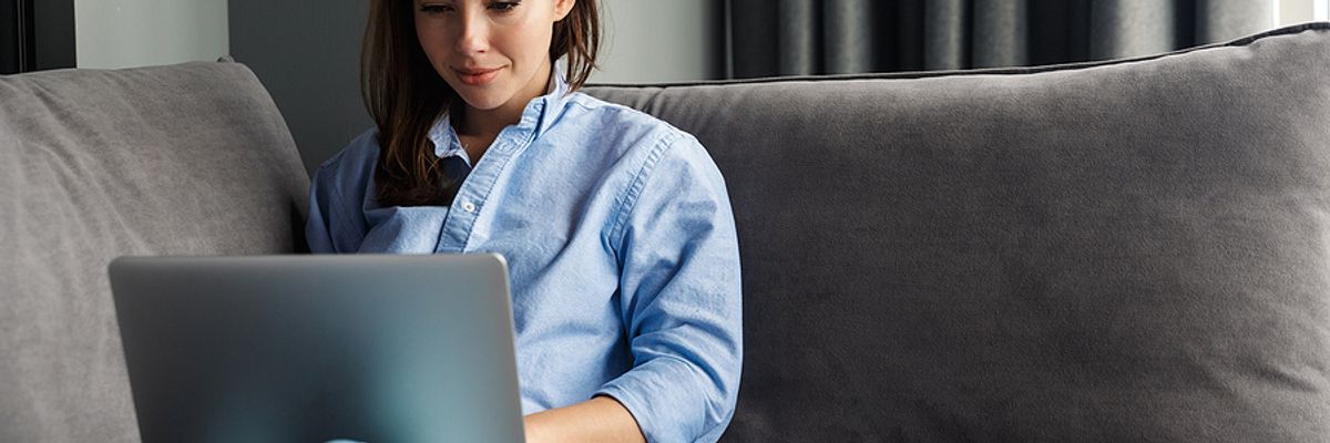 Businesswoman works remotely from the comfort of her own home.