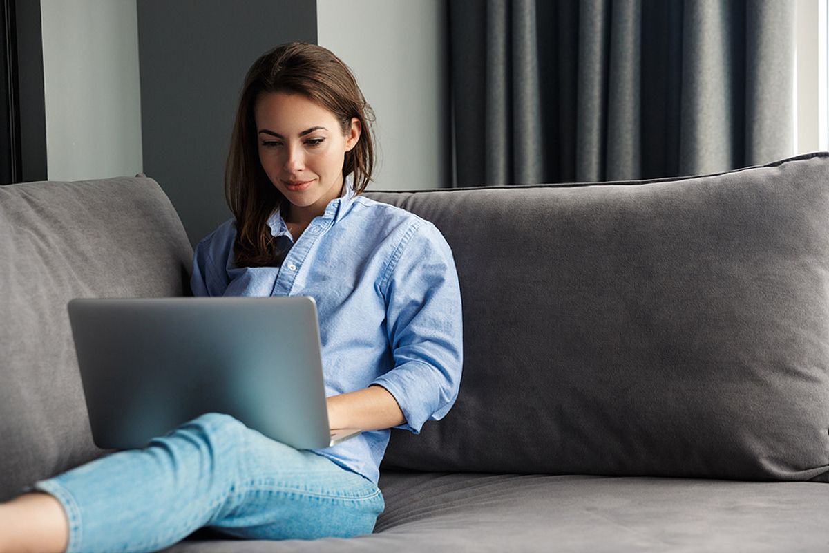 Businesswoman works remotely from the comfort of her own home.