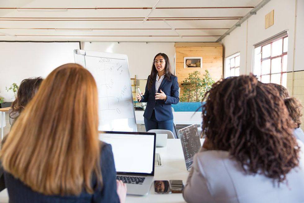 Businesswomen meet to discuss employer branding strategy.