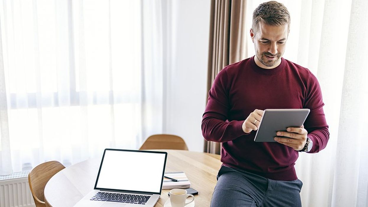 Busy executive on tablet stays up to date on trends