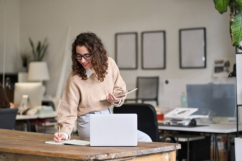 Busy executive writes down current trends to stay up to date