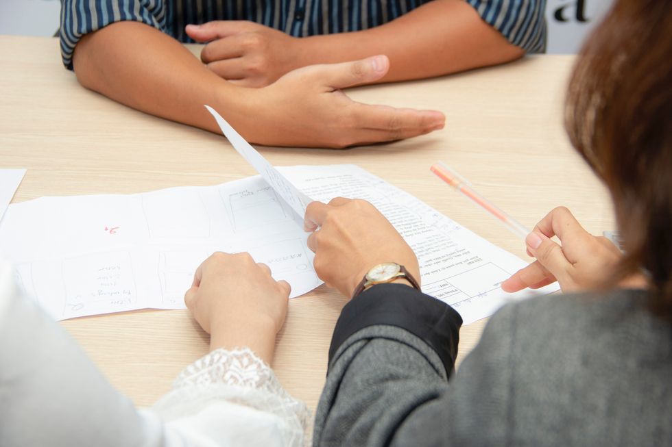 Career coach reviews a job seeker's resume and cover letter