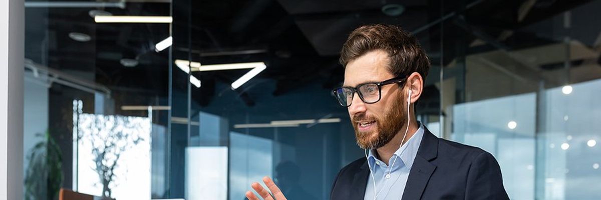 CEO/leader on laptop talking during a remote work meeting