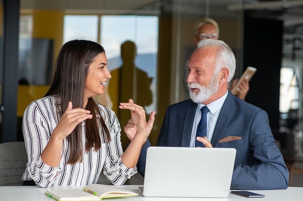 CEO/leader talks to an employee at work