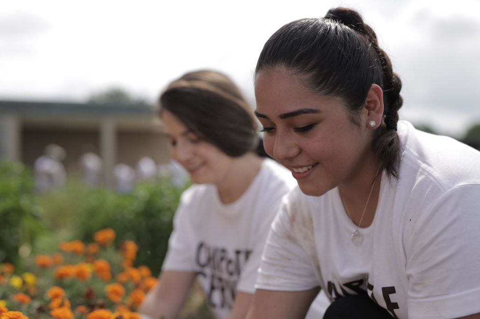 Chipotle employees work at a recent community service project