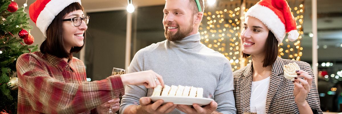 Co-workers celebrate the holidays with tasty treats at their office party