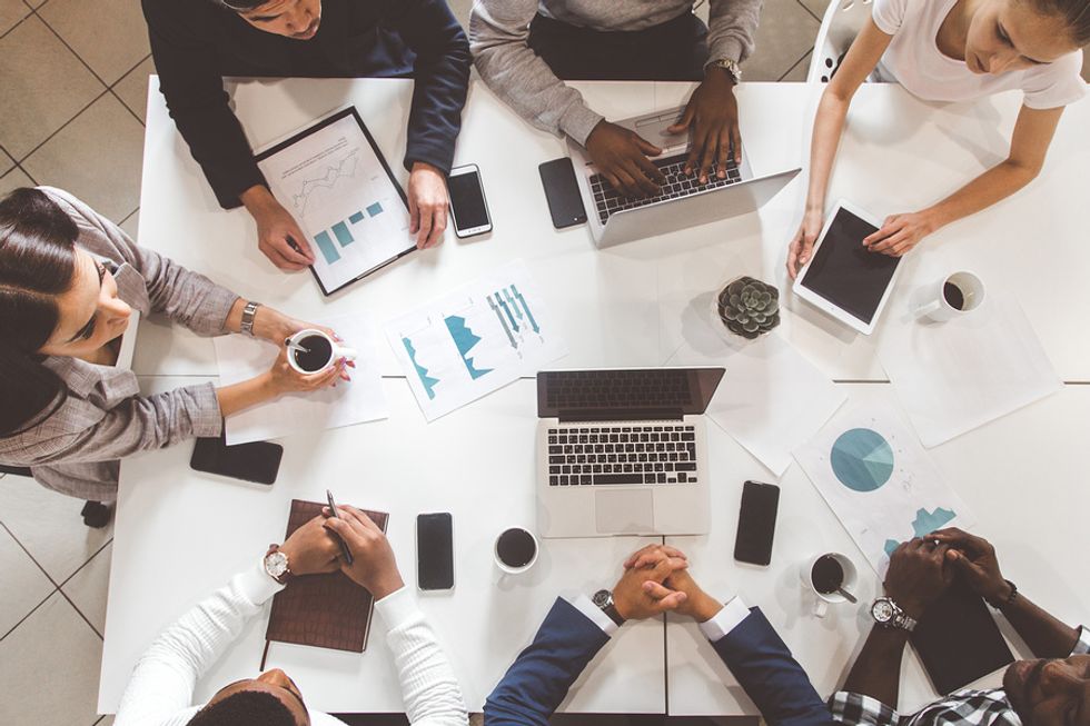 Co-workers meet to reach the performing stage of team development