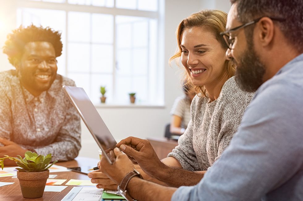 Co-workers set goals for the next week during a work meeting