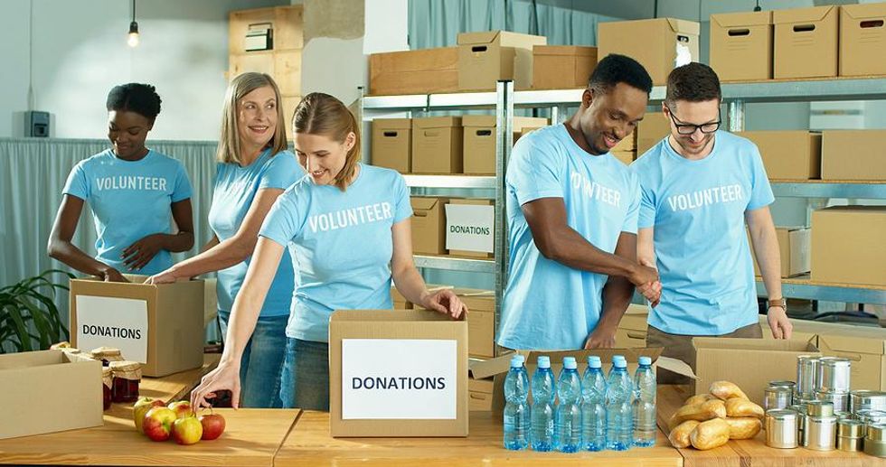 Colleagues volunteer at a food pantry together