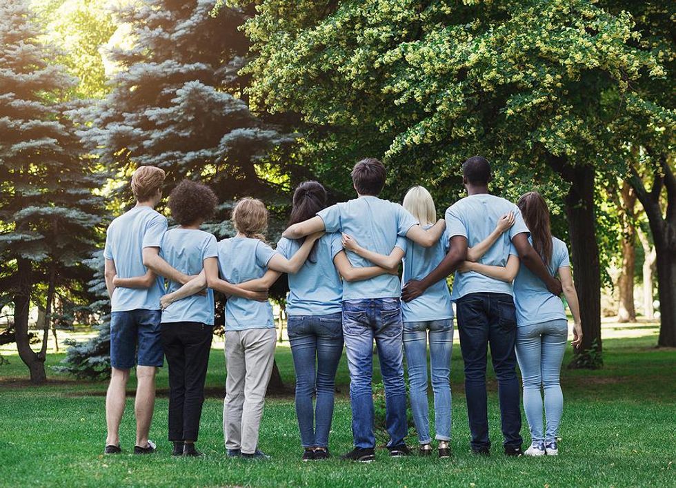 Colleagues volunteer together at a park