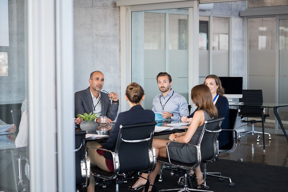 Company leaders discuss how to move forward following a layoff during a meeting