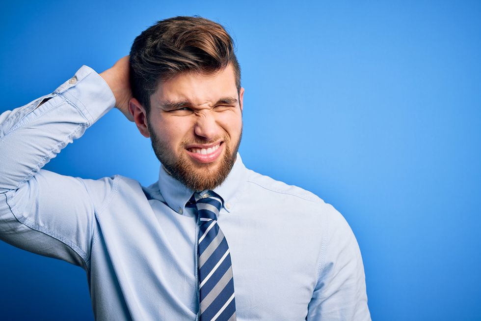 Confused businessman ponders whether or not he should take a cut in salary