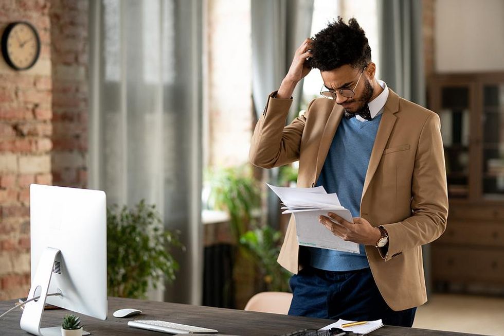 Confused man looks at his resume