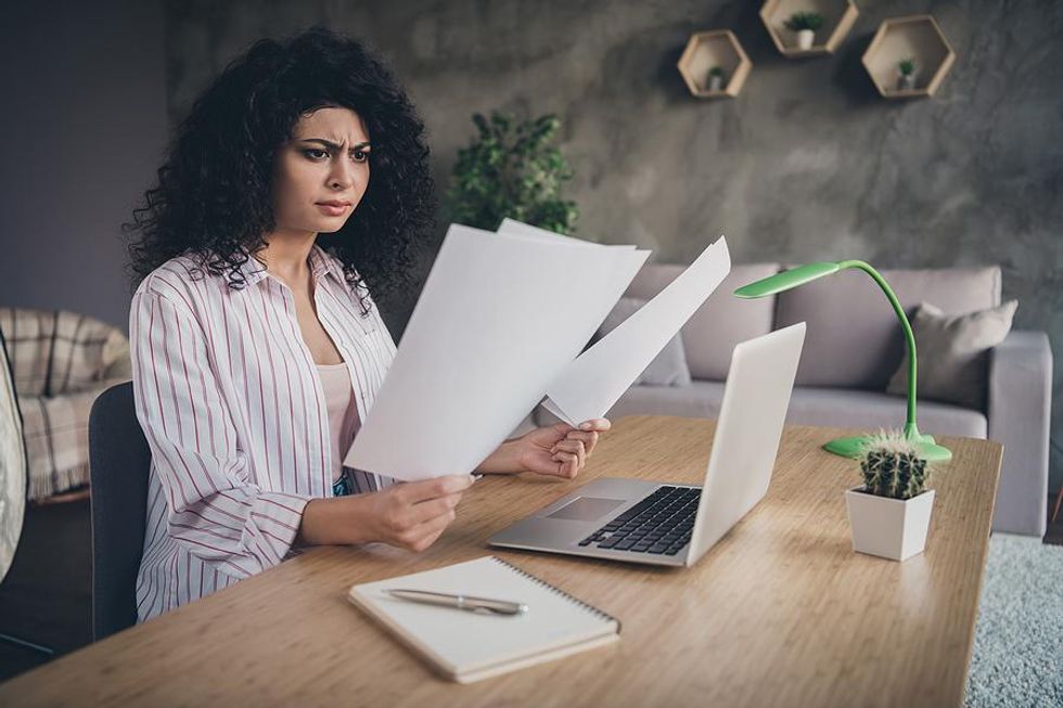 Confused woman looks at her resume