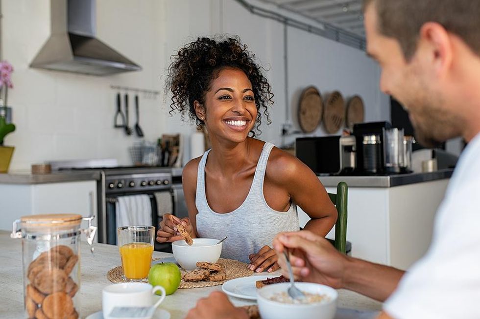 Couple eats breakfast together before going to work
