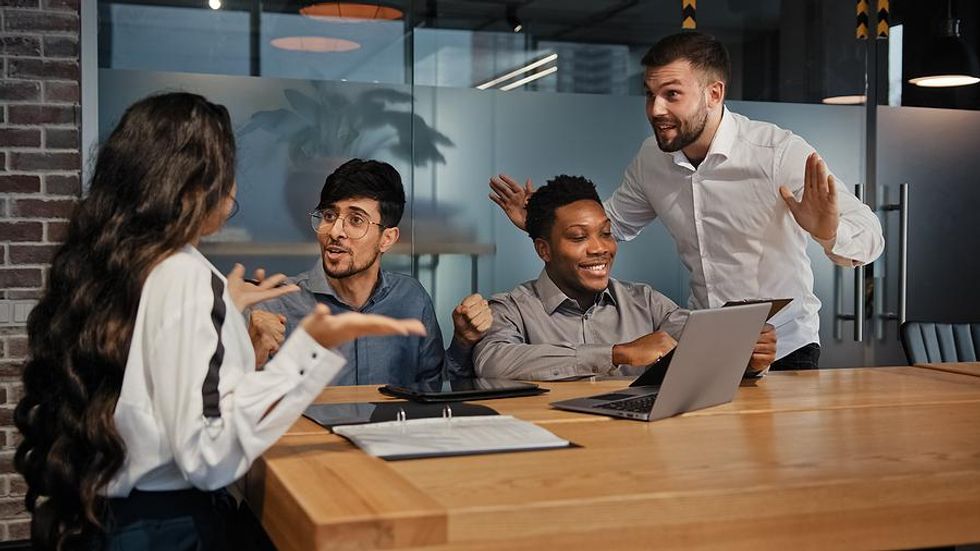 Coworkers argue during a work meeting