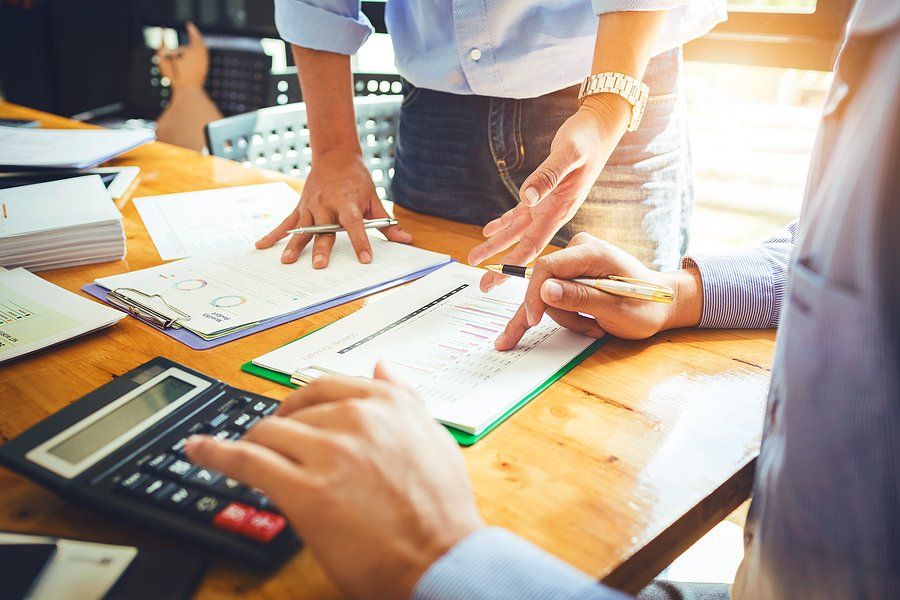 Coworkers in a meeting talk about operational challenges