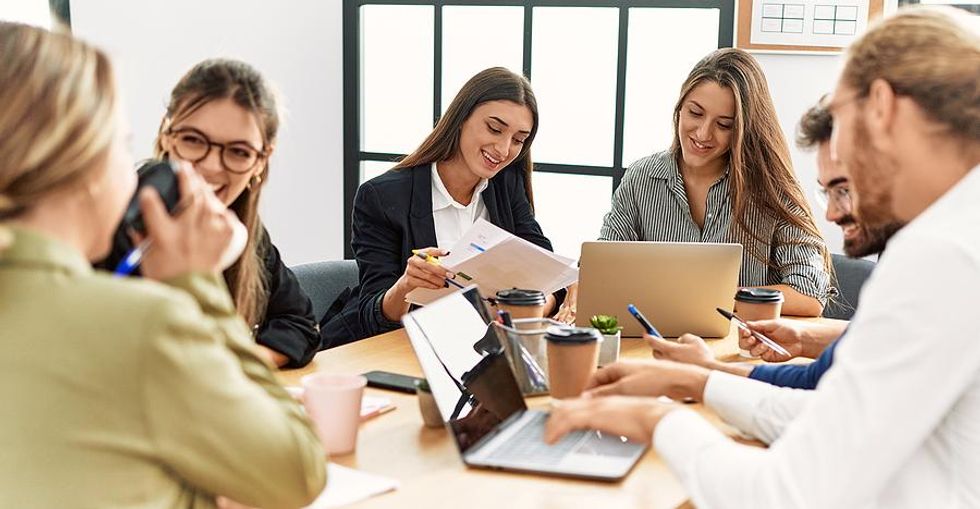 Coworkers in meeting work to solve a problem