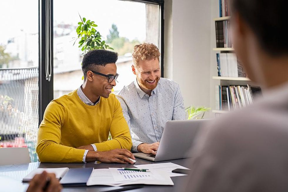 Coworkers laugh during a meeting