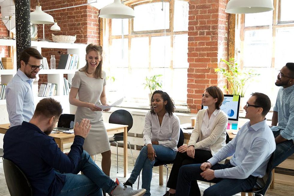 Coworkers laugh during a work meeting