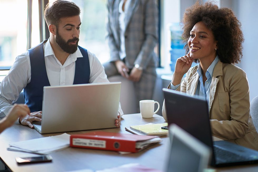Coworkers talk about their industry during a meeting