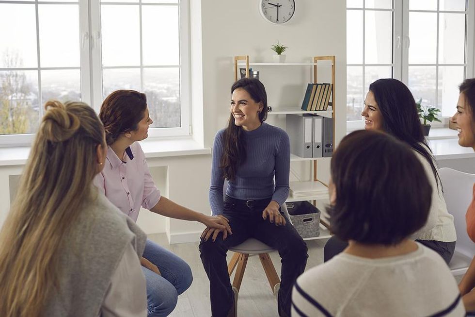 Coworkers talk during a team meeting