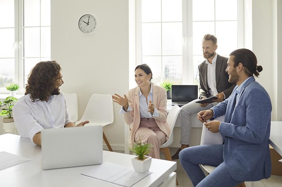 Coworkers talk in the office