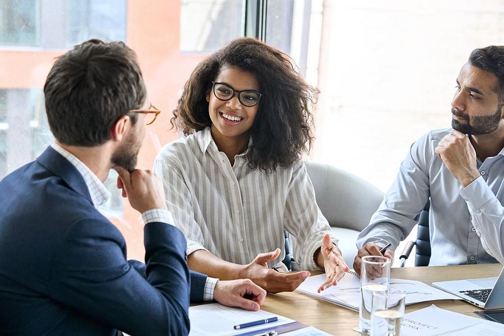 Coworkers talk strategy during a business meeting