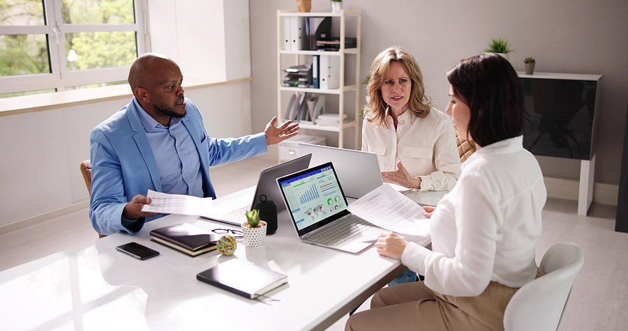 Coworkers try to resolve a conflict during a work meeting