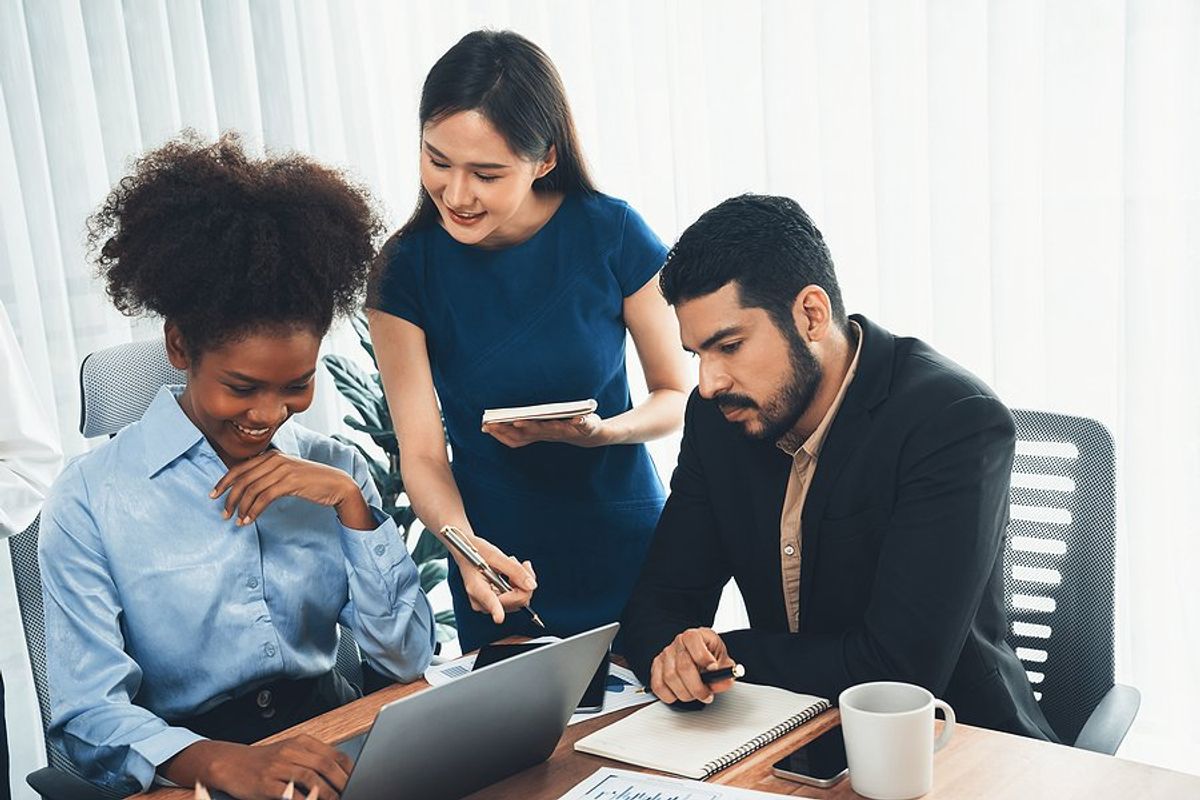 Coworkers with good office etiquette work on a project together