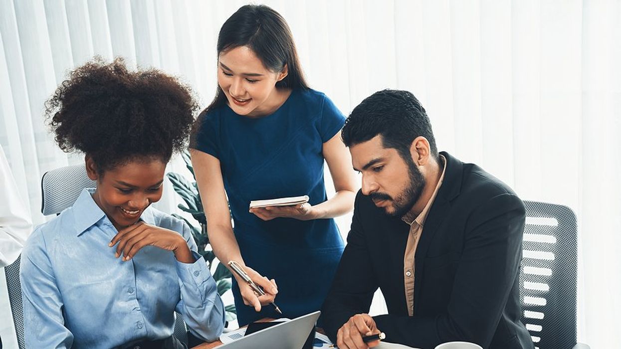 Coworkers with good office etiquette work on a project together