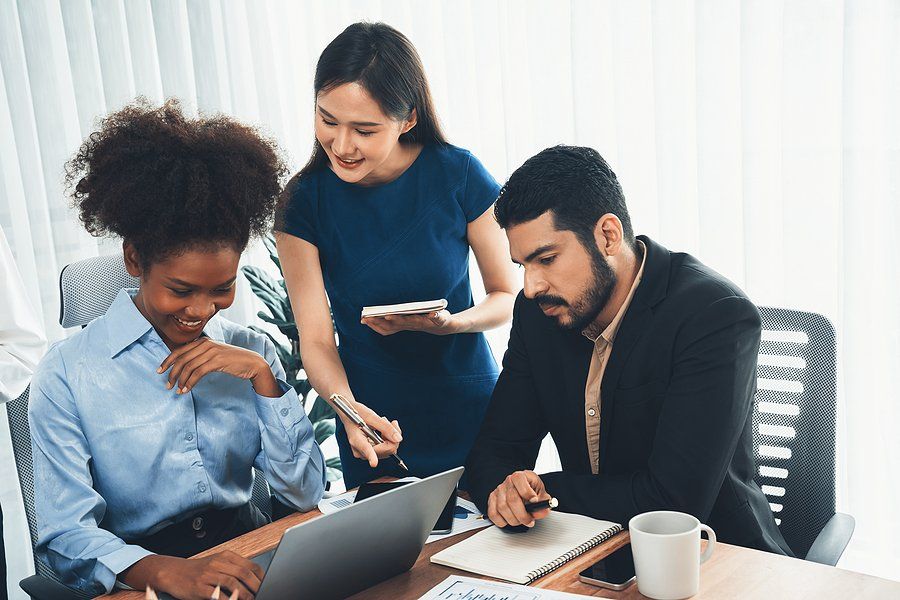 Coworkers with good office etiquette work on a project together