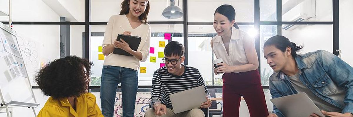 Creative employees work on a project together