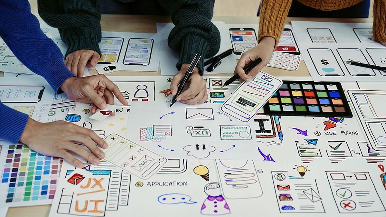 Creative professionals use a strategy for project success during a meeting