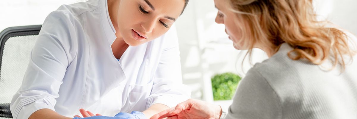 Dermatologist examining a patient
