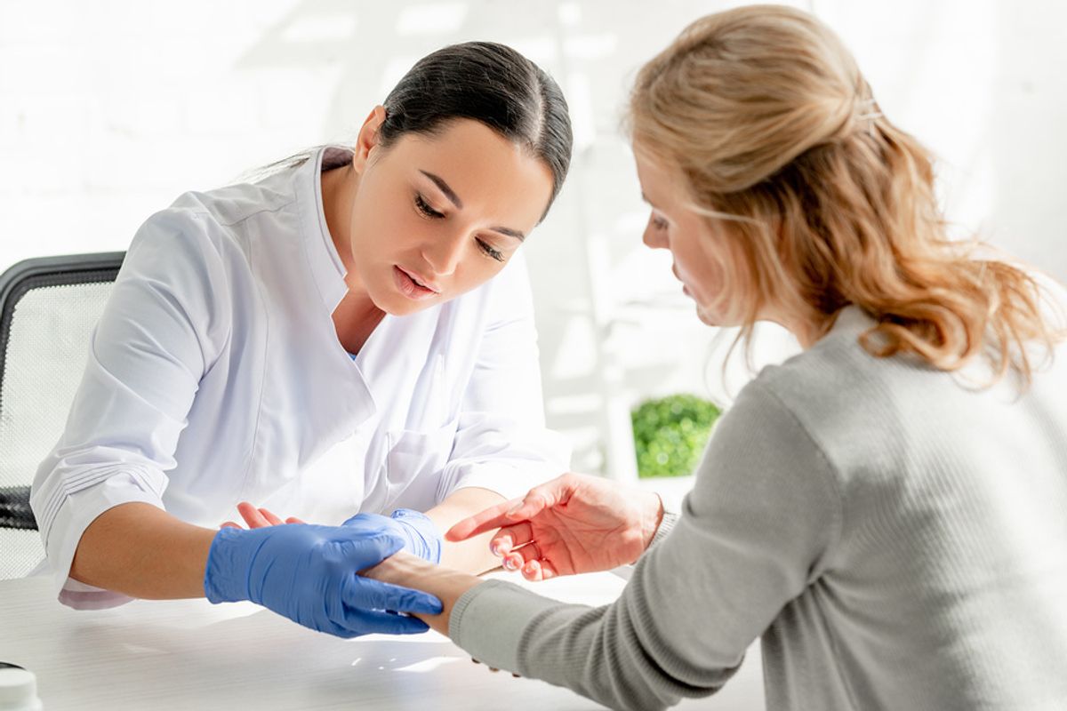 Dermatologist examining a patient