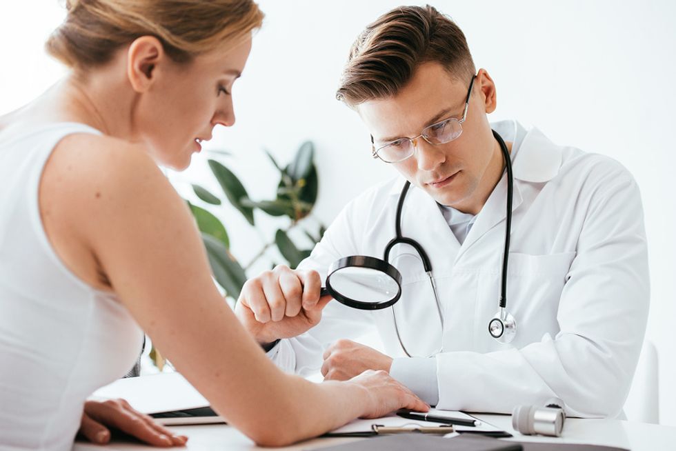 Dermatologist looking at a patient's hand