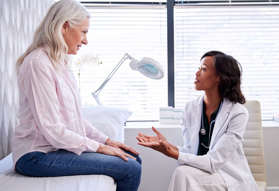 Dermatologist talking to a patient during an appointment