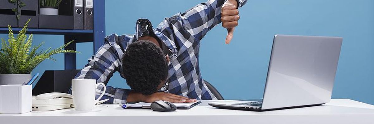 Distressed man working on a project on his laptop